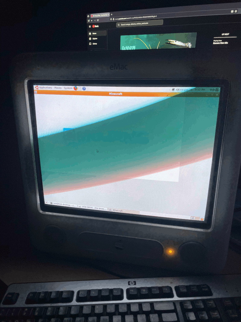An eMac in a dark room with an off-colour Minecraft loading window